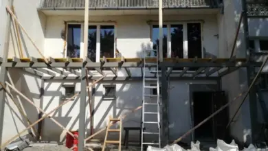 Stavba domu s novými okny na fasádě v procesu rekonstrukce.