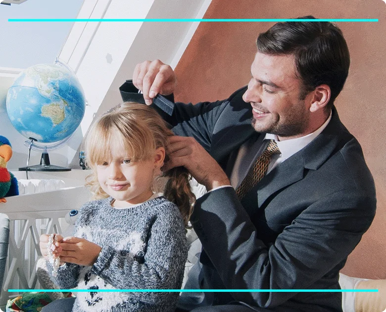 Father combing daughter's hair